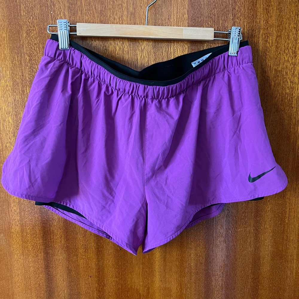 This is a pair of purple Nike Dri-Fit workout shorts with built-in short liner.
